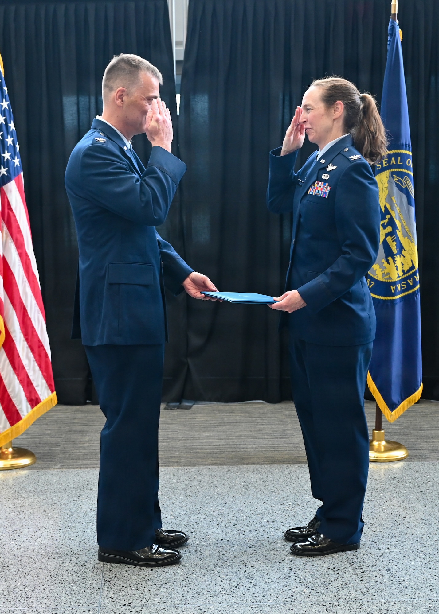 Col. Brooke Sciuto, outgoing 155th Medical Group commander, salutes Col. Christopher Hesse, 155th Air Refueling Wing commander, at her change of command ceremony, April 11, 2026, at the Nebraska National Guard air base in Lincoln, Nebraska. Sciuto thanked Hesse for his leadership and friendship over the past four years. (U.S. Air National Guard photo by Tech. Sgt. Phil Cowen)
