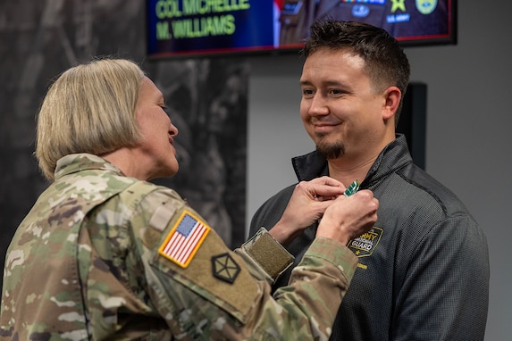 Col. Michelle M. Williams, U.S. Army Financial Management Command commander, presents Cory K. Henck, USAFMCOM Resource Management (G-8) accountant, with a U.S. Army civilian service commendation medal during a town hall at the Maj. Gen. Emmett J. Bean Federal Center Jan. 12, 2026. Harwood was presented the medal on behalf of Lt. Gen. Christopher M. Mohan, U.S. Army Materiel Command deputy commanding general and acting commander, for being recognized as an AMC employee of the quarter for the third quarter of Fiscal Year 2025. (U.S. Army photo by Mark R. W. Orders-Woempner)