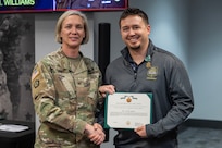 Col. Michelle M. Williams, U.S. Army Financial Management Command commander, presents Cory K. Henck, USAFMCOM Resource Management (G-8) accountant, with a U.S. Army civilian service commendation medal during a town hall at the Maj. Gen. Emmett J. Bean Federal Center Jan. 12, 2026. Harwood was presented the medal on behalf of Lt. Gen. Christopher M. Mohan, U.S. Army Materiel Command deputy commanding general and acting commander, for being recognized as an AMC employee of the quarter for the third quarter of Fiscal Year 2025. (U.S. Army photo by Mark R. W. Orders-Woempner)