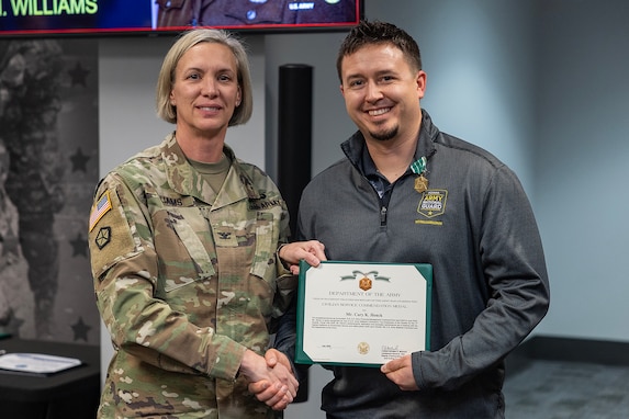 Col. Michelle M. Williams, U.S. Army Financial Management Command commander, presents Cory K. Henck, USAFMCOM Resource Management (G-8) accountant, with a U.S. Army civilian service commendation medal during a town hall at the Maj. Gen. Emmett J. Bean Federal Center Jan. 12, 2026. Harwood was presented the medal on behalf of Lt. Gen. Christopher M. Mohan, U.S. Army Materiel Command deputy commanding general and acting commander, for being recognized as an AMC employee of the quarter for the third quarter of Fiscal Year 2025. (U.S. Army photo by Mark R. W. Orders-Woempner)