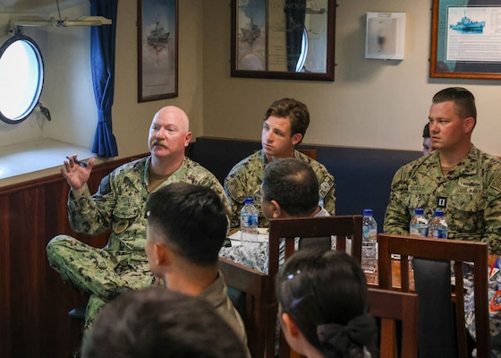 Cmdr. Adam Peeples, commanding officer of Whidbey Island-class dock landing ship USS Ashland (LSD 48) speaks during a planning session aboard HMAS Toowoomba (FFH 156) with members of the Armed Forces of the Philippines and Royal Australian Navy as part of multilateral Maritime Cooperative Activity (MCA), April 10, 2026. The U.S. Navy routinely operates with the Armed Forces of the Philippines and partners and allies through MCAs to continually develop, exercise and enhance multi-domain tactical interoperability to uphold peace and security in the region. (U.S. Navy photo by Mass Communication Specialist 1st Class John B. Hetherington)