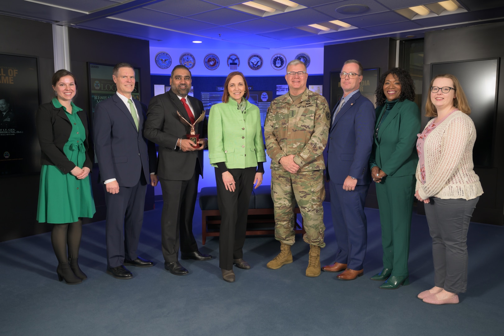 DLA Director posing with award winners