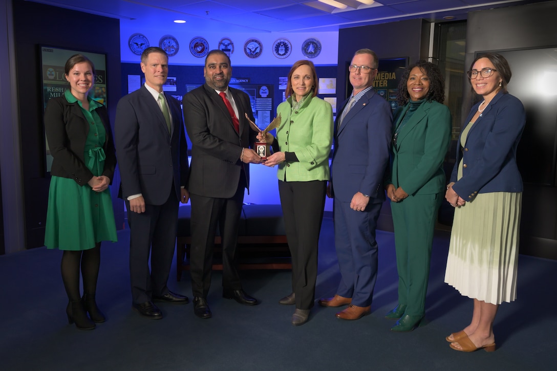 DLA leadership posing with award.