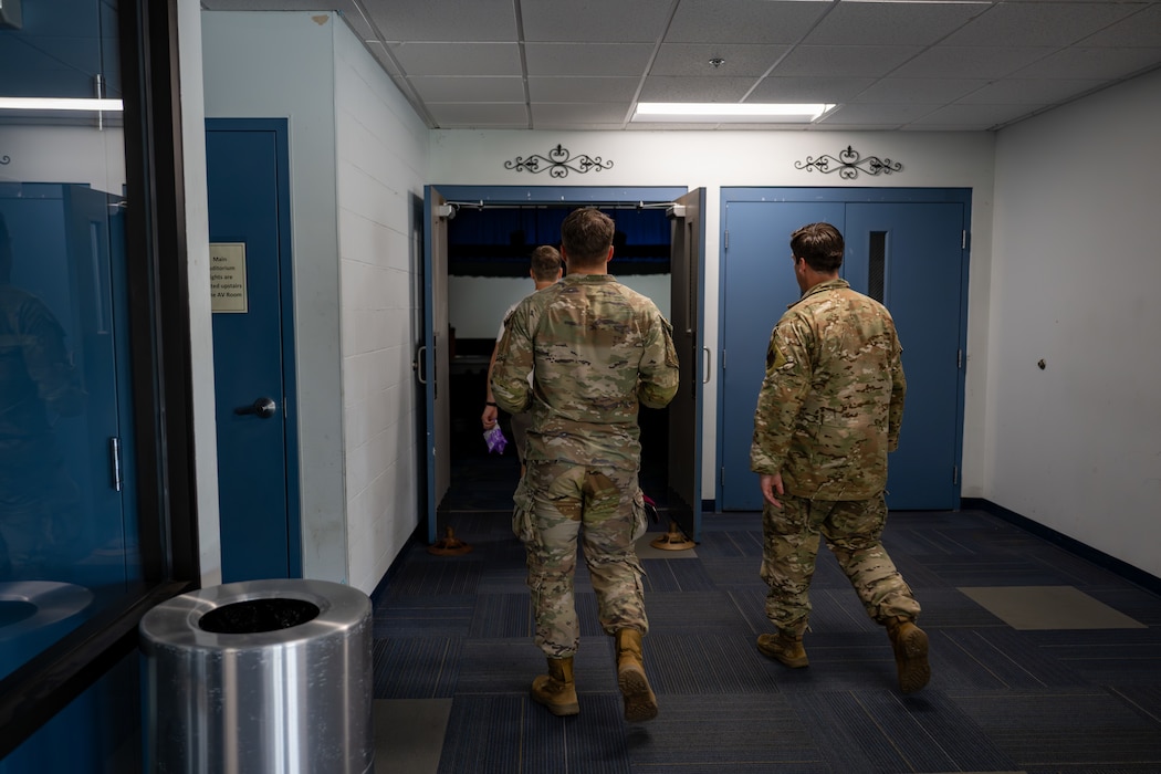 People walking into a theater.