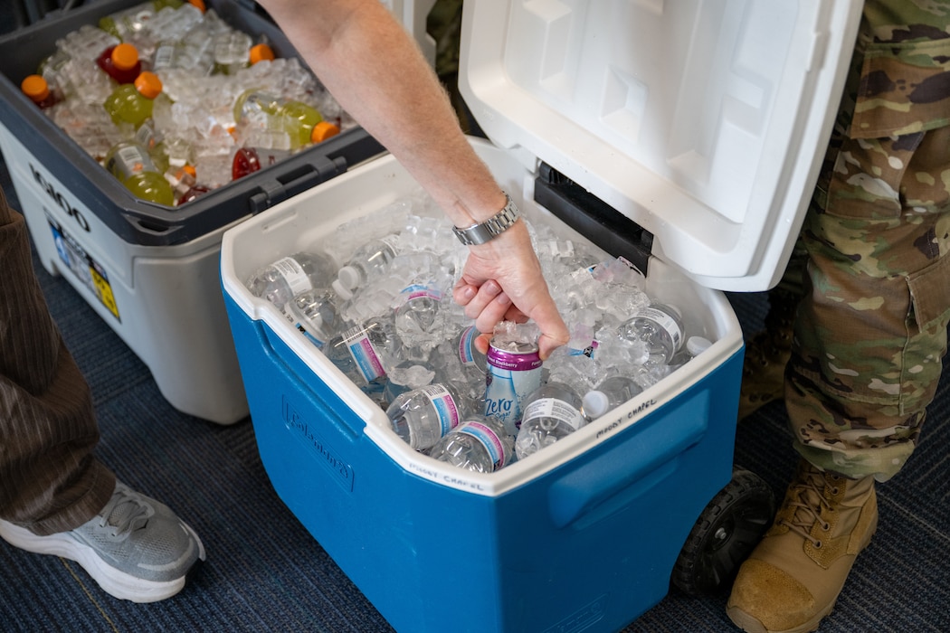 Hand reaches into cooler.