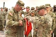 U.S. Army 1st Sgt. Brandon Lutz, with Delta Troop, 2nd Squadron, 104th Cavalry Regiment, 56th Mobile Brigade Combat Team, 28th Infantry Division, retires the troop guidon with the assistance of Cpt. Robert Tomlinson III during the 2-104 Cav deactivation ceremony on Fort Indiantown Gap, Pa., March 21, 2026. Lutz, along with the other soldiers in D Troop, have since been integrated into the newly established Mike Company, 56th Mobile Brigade Combat Team. (U.S. Army National Guard photo by Sgt. 1st Class Oriana White)