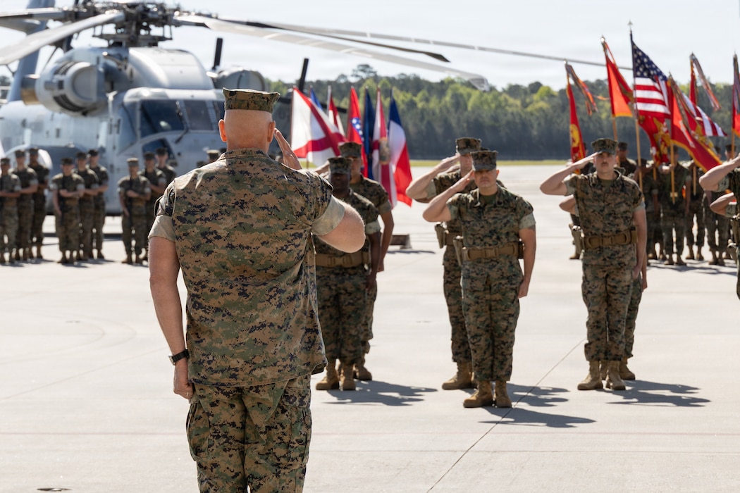 U.S. Marine Corps Col. Everett Good, center, from Missouri, the commanding officer of Marine Aircraft Group 29, 2nd Marine Aircraft Wing, salutes during a relief and appointment ceremony at Marine Corps Air Station New River, North Carolina, April 10, 2026. The ceremony represented the transfer of authority, accountability and leadership from Sgt. Maj. Daniel Haber, from Ohio, the outgoing command senior enlisted leader of MAG-29 to Sgt. Maj. Melisa Cancienne, from Florida, the incoming command senior enlisted leader. (U.S. Marine Corps photo by Cpl. Anakin Smith)