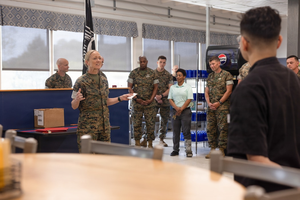 U.S. Marine Corps Brig. Gen. Maura M. Hennigan, left, commanding general of 2nd Marine Logistics Group, speaks to Marines, Sailors, and mess hall attendants during an award ceremony at Marine Corps Base Camp Lejeune, North Carolina, April 6, 2026. The mess hall attendants earned the Major General W.P.T. Hill Memorial Award for “Best Management and Mess Attendant Mess Hall” in recognition of their professionalism, commitment, and expertise, which have brought great credit upon themselves, the Installations and Logistics mission, the food service community, and the Marine Corps. Hennigan is a native of New York. (U.S. Marine Corps photo by Lance Cpl. Talan Werner)