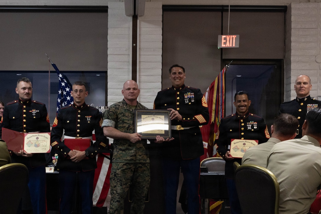 U.S. Marines Corps Brig. Gen. Michael Nakonezcny, the deputy commanding general of I Marine Expeditionary Force, poses for a photo with Marines with 4th Light Armored Reconnaissance Battalion, 4th Marine Division, during an awards dinner following the conclusion of the Bushmaster 26 Competition at Marine Corps Base Camp Pendleton, California, March 29, 2026. The 2026 Bushmaster Competition, hosted by 4th Light Armored Reconnaissance Battalion, 4th Marine Division, is a multi-event challenge hosted annually by the U.S. Marine Corps Light Armored Reconnaissance community that evaluates LAV-25 crews, including ally partners, on tactical proficiency, marksmanship, physical endurance, and reconnaissance skills. (U.S. Marine Corps photo by Cpl. Sawyer Carleton)
