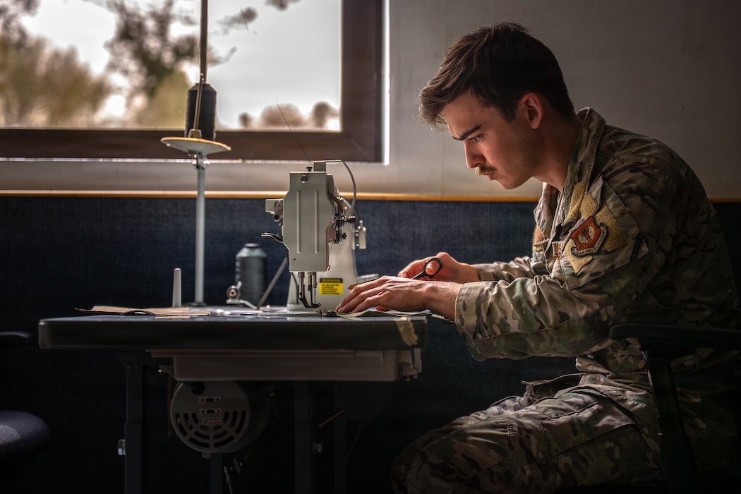 U.S. Air Force Senior Airman Evan Kurimoto, 86th Operational Support Squadron aircrew equipment journeyman, sews a patch at Ramstein Air Base, Germany, April 10, 2026.