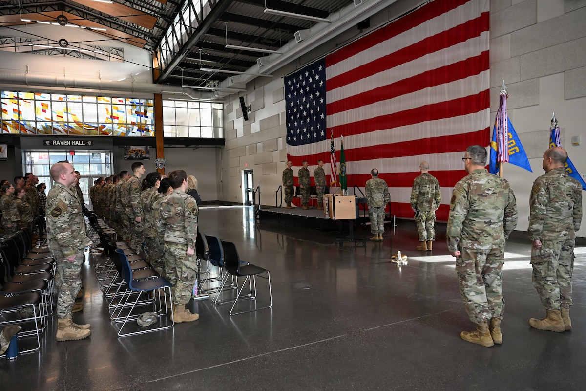 U.S. Airmen with the 143rd Cyberspace Operations Squadron and 194th Intelligence Squadron, Washington Air National Guard, stand at attention for “The Star-Spangled Banner” during their mobilization ceremony at Camp Murray, Wash., April 3, 2026.