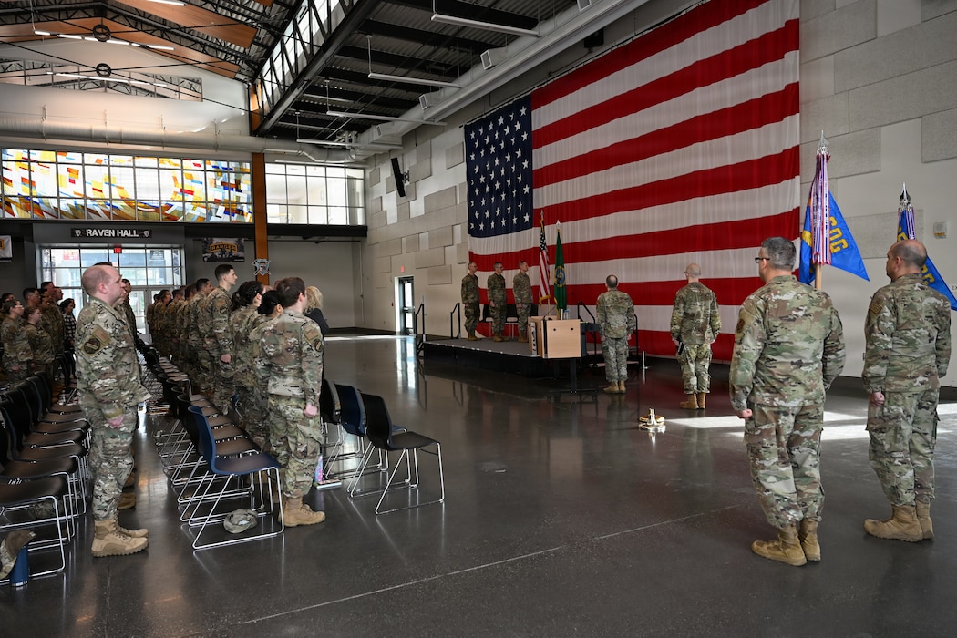 U.S. Airmen with the 143rd Cyberspace Operations Squadron and 194th Intelligence Squadron, Washington Air National Guard, stand at attention for “The Star-Spangled Banner” during their mobilization ceremony at Camp Murray, Wash., April 3, 2026.