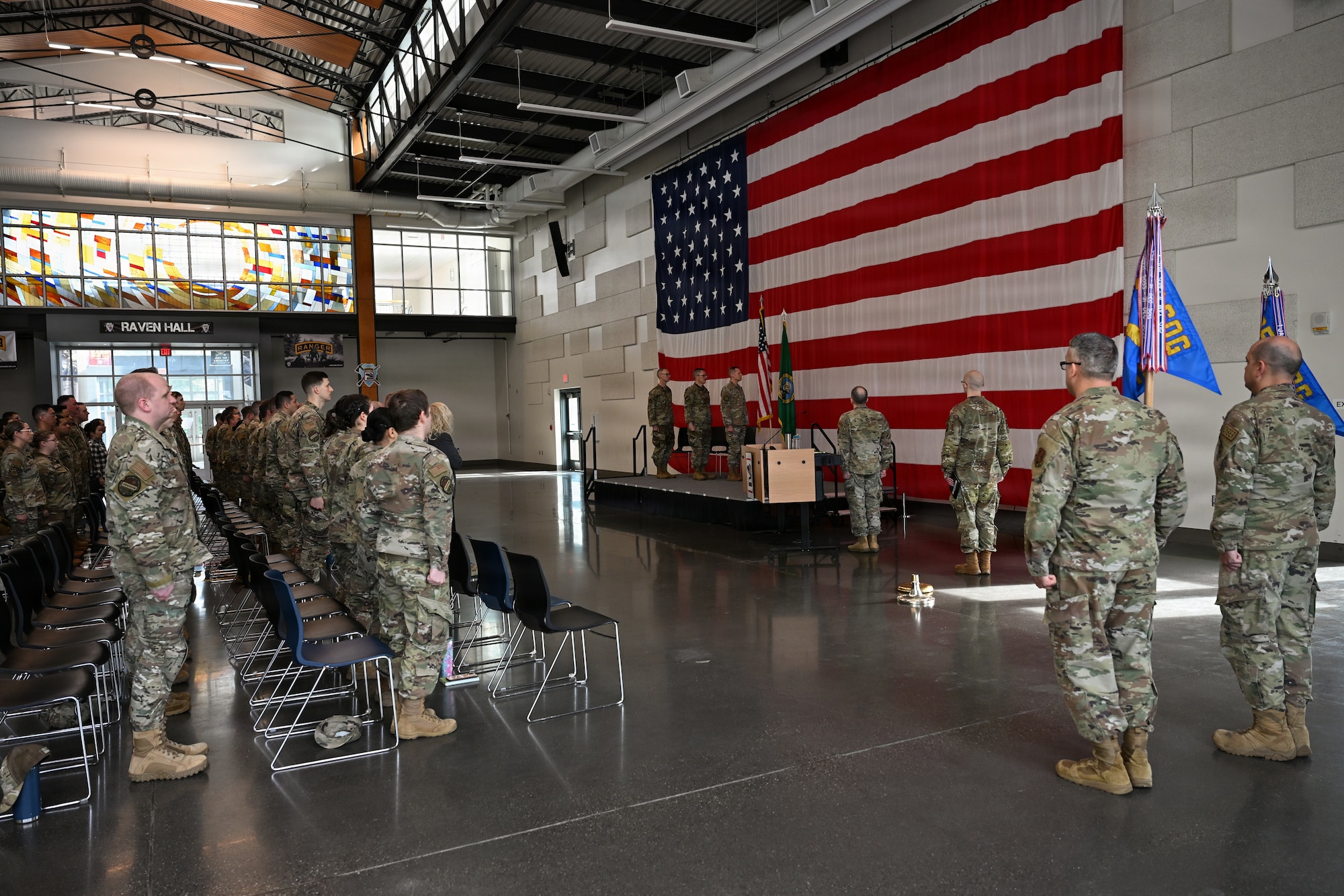 U.S. Airmen with the 143rd Cyberspace Operations Squadron and 194th Intelligence Squadron, Washington Air National Guard, stand at attention for “The Star-Spangled Banner” during their mobilization ceremony at Camp Murray, Wash., April 3, 2026.