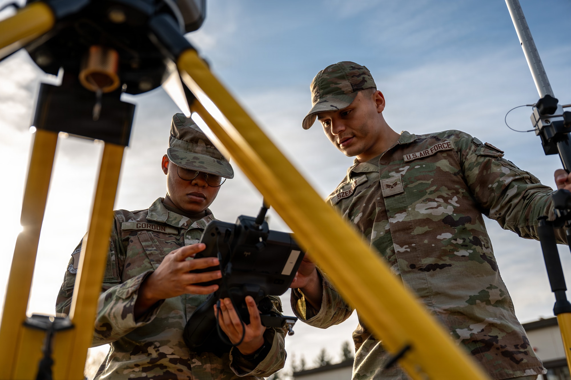 U.S. Air Force Airman 1st Class Neveah Gordon, left, 86th Civil Engineer Squadron geo base apprentice and U.S. Air Force Senior Airman Kevin Szekely, 86th CES geo base journeyman, interprets data from the Trimble SX12 robot at Ramstein Air Base, Germany, April 9, 2026.