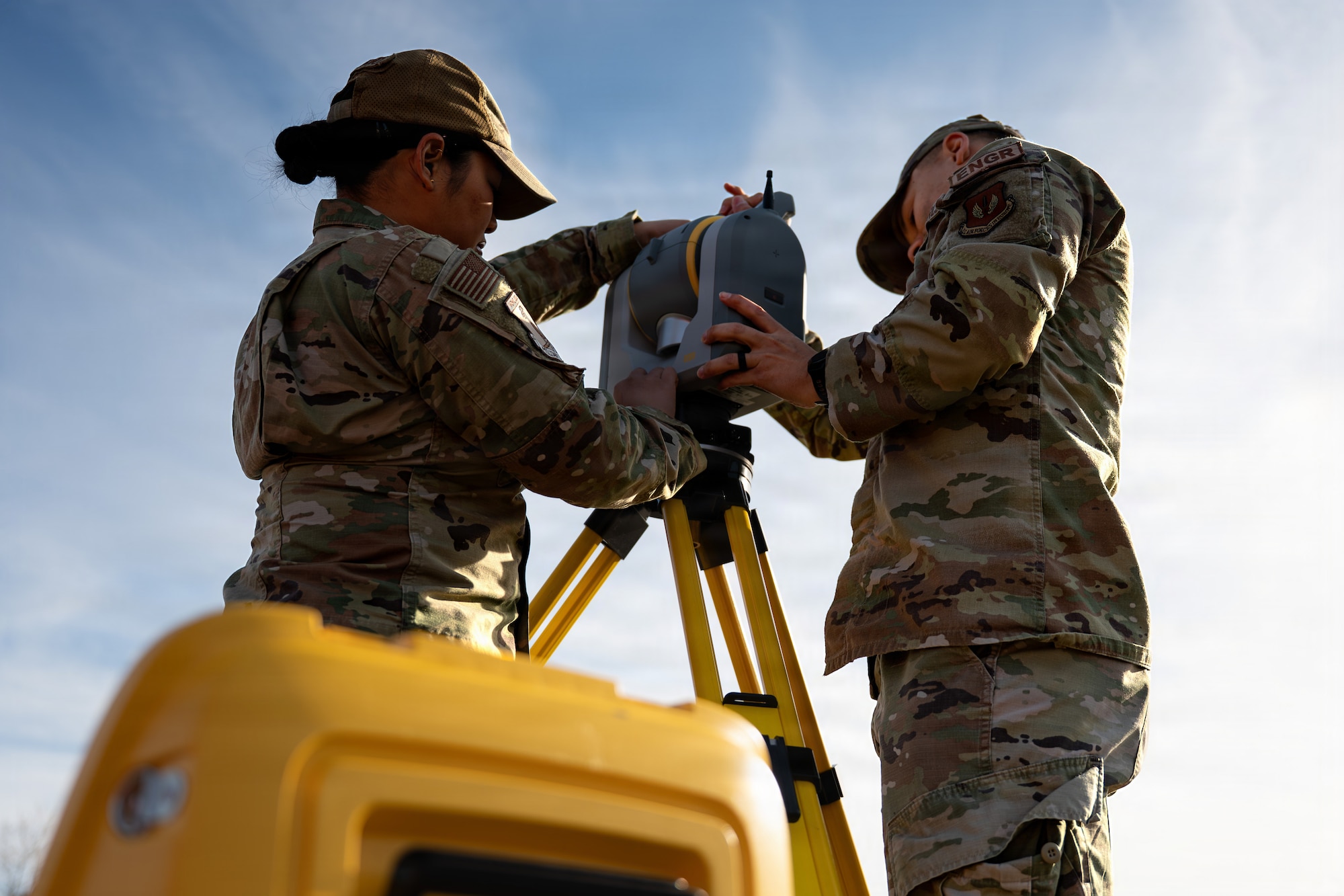 U.S. Air Force Senior Airman Bea Angel Gerundio, 86th Civil Engineering Squadron geo base apprentice left, and Senior Airman Kevin Szekely, right, 86th Civil Engineering Squadron geo base journeyman, set-up the Trimble SX12 robot at Ramstein Air Base, Germany, April 9, 2026.