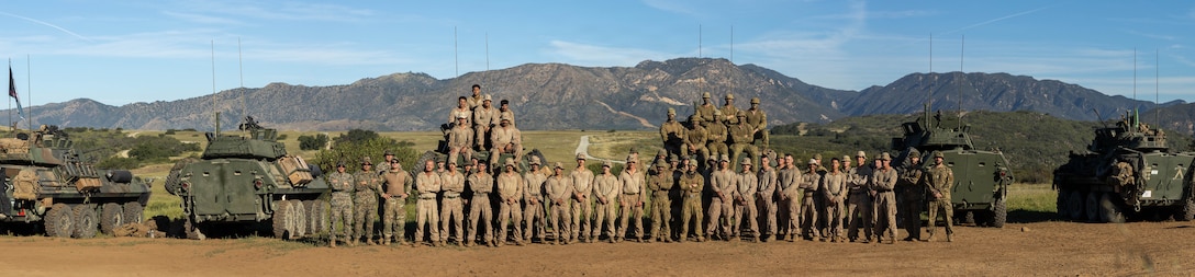 U.S. Marines, alongside Australian Army soldiers from the School of Armor, 2nd/14th Light Horse Regiment, Queensland Mounted Infantry, and New Zealand Defense Force soldiers with 1st Battalion, Queen Alexandra’s Mounted Rifles, pose for a photo during the final phase of the Bushmaster 26 Competition at Marine Corps Base Camp Pendleton, California, March 27, 2026. The 2026 Bushmaster Competition, hosted by 4th Light Armored Reconnaissance Battalion, 4th Marine Division, is a multi-event challenge hosted annually by the U.S. Marine Corps Light Armored Reconnaissance community that evaluates LAV-25 crews, including ally partners, on tactical proficiency, marksmanship, physical endurance, and reconnaissance skills. (U.S. Marine Corps photo by Cpl. Sawyer Carleton)