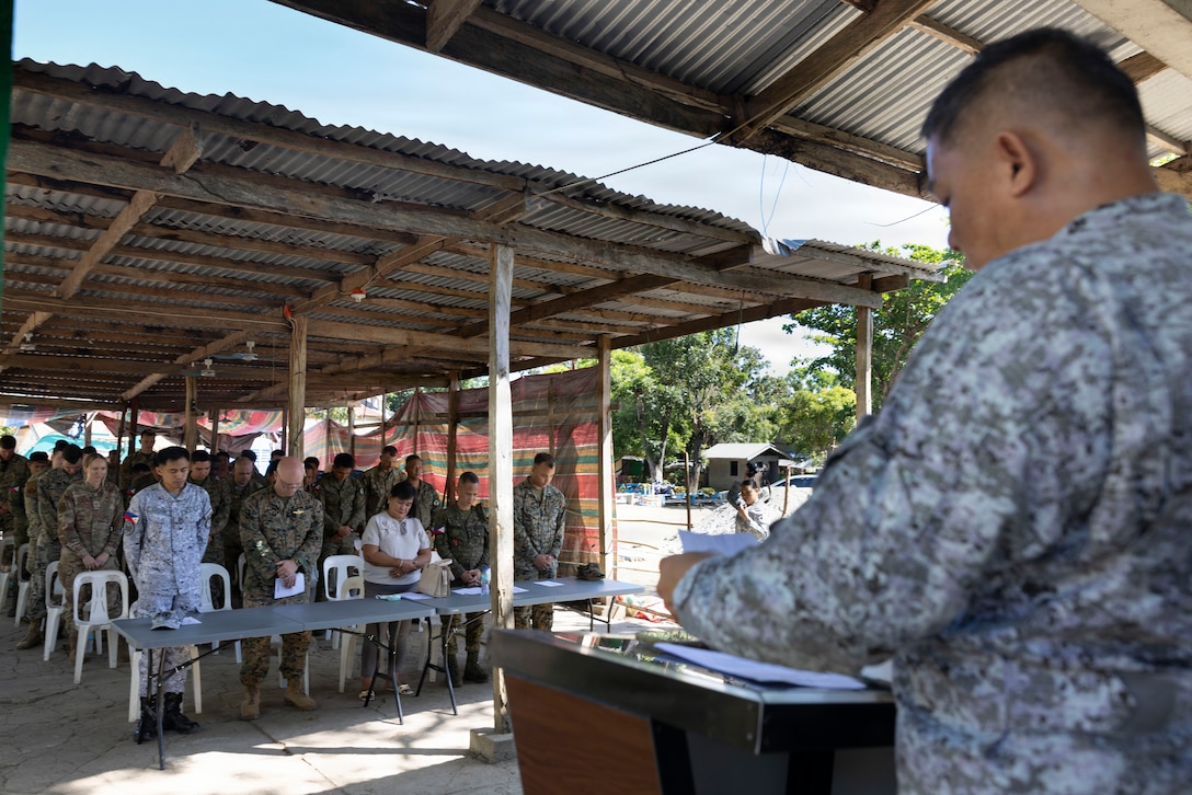 Philippine Air Force Tech. Sgt. Conan Cruz delivers the invocation prior to a Bundle of Joy ceremony during a civic-military engagement supporting Exercise Balikatan 2026 in San Narciso, Quezon, Philippines, April 9, 2026. Balikatan is a longstanding annual exercise between the Armed Forces of the Philippines and U.S. military designed to strengthen our ironclad alliance, improve our capable combined force, and demonstrate our commitment to regional security and stability. (U.S. Marine Corps photo by Lance Cpl. Mia Ocampo)
