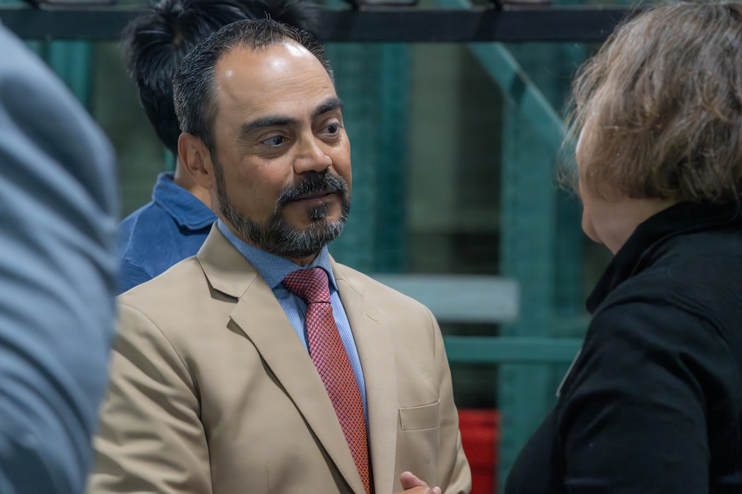 An Executive Director speaks with an Honorary Commander.