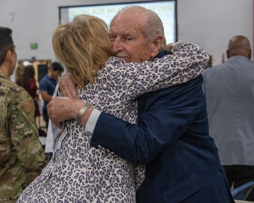 A Travis Golden Bear embraces an Honorary Commander.