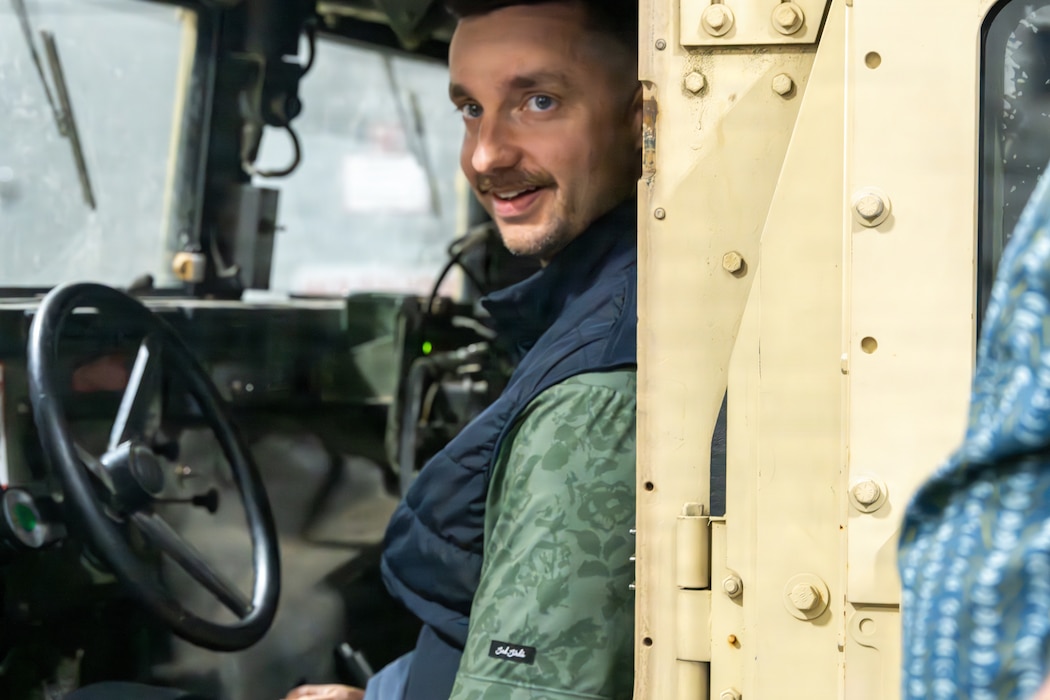 An Honorary Commander sits in a Humvee.