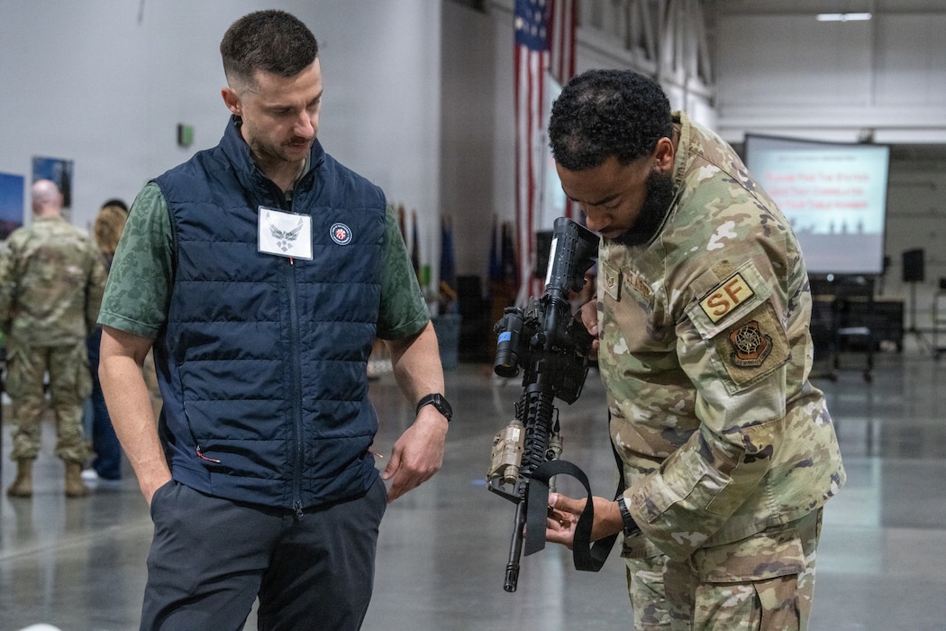 An Honorary Commander learns about an M4 carbine.