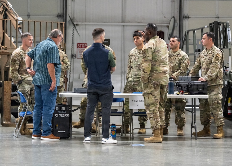 Honorary Commanders speak with a group of Airmen.