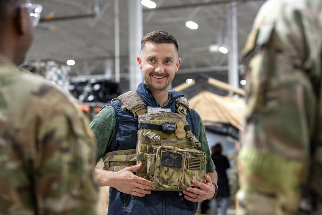 An Honorary Commander tries on a plate carrier.