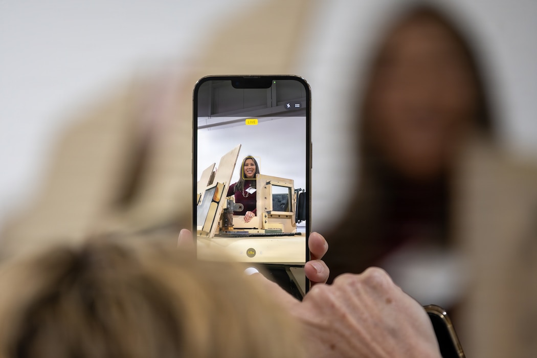 An Honorary Commander photographed standing in a Humvee.