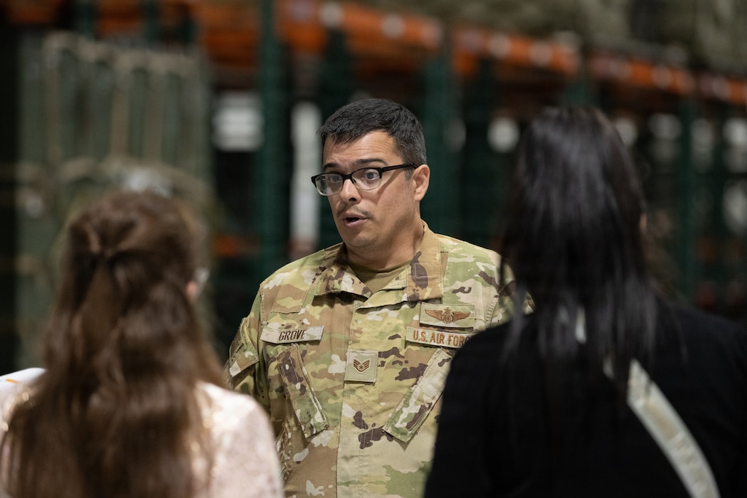 An Airman speaks with Honorary Commanders.