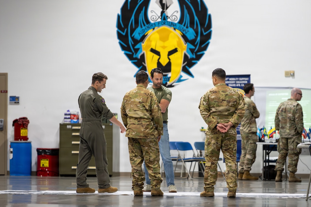 Airmen speak with Honorary Commanders.