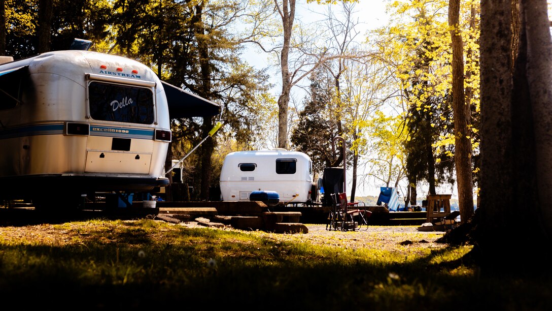 Recreational trailers sit nestled among trees at Seven Points Campground on the shoreline of J. Percy Priest Lake in Hermitage, Tennessee. The campsite is an awesome home base for recreation where visitors can relax and take advantage of activities such as hiking, swimming, and boating. Corps campgrounds offer great amenities such as bathrooms with showers, electric and water hookups, dump stations, laundry rooms, playgrounds, and boat ramps.  (USACE Photo by Christopher Grissett)