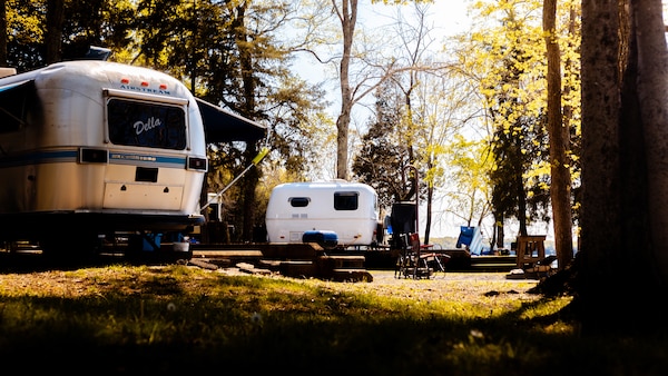 Recreational trailers sit nestled among trees at Seven Points Campground on the shoreline of J. Percy Priest Lake in Hermitage, Tennessee. The campsite is an awesome home base for recreation where visitors can relax and take advantage of activities such as hiking, swimming, and boating. Corps campgrounds offer great amenities such as bathrooms with showers, electric and water hookups, dump stations, laundry rooms, playgrounds, and boat ramps.  (USACE Photo by Christopher Grissett)