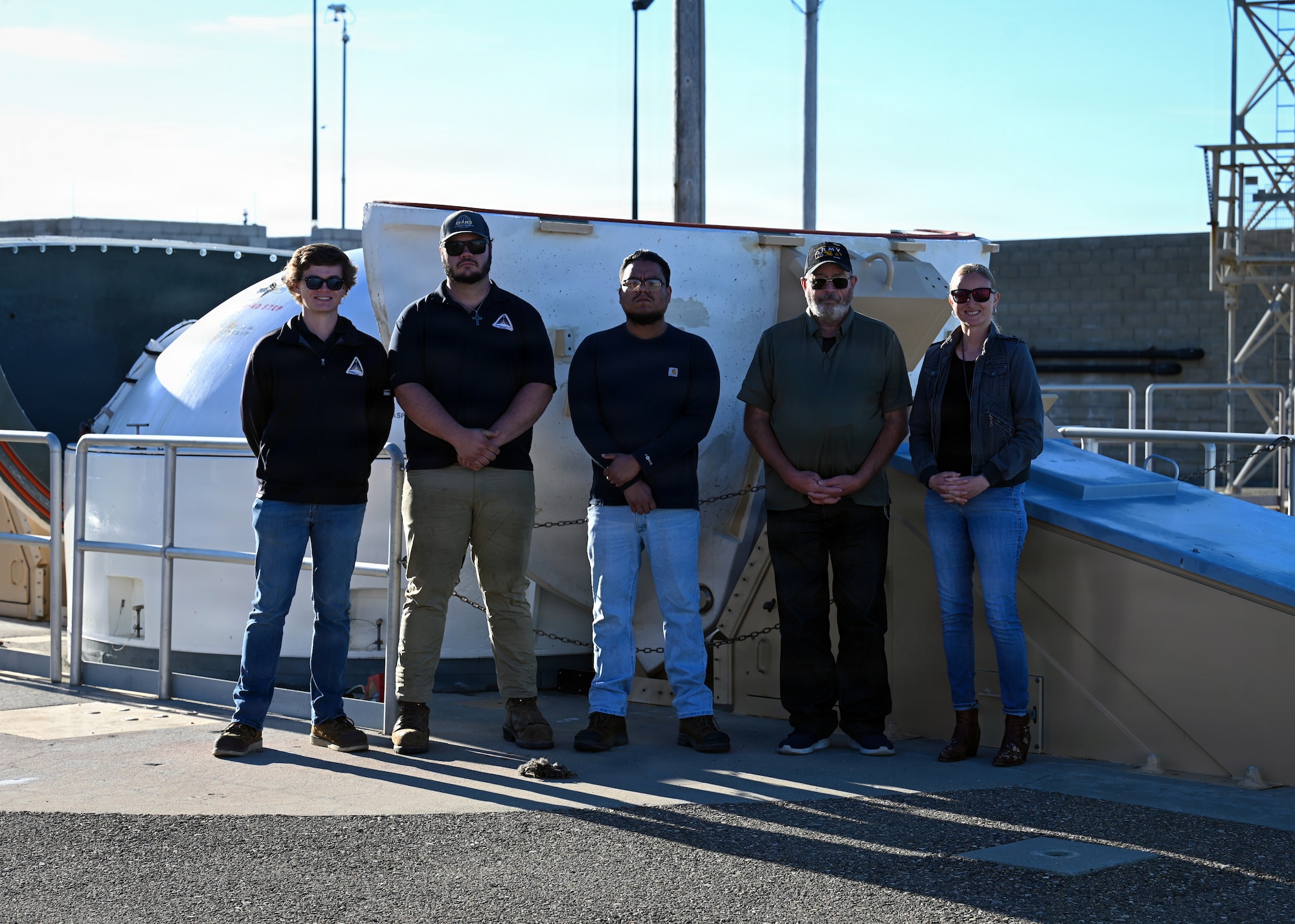 Members of the Virginia Spaceport Authority pose for a group photo during a visit to a Ground Based Interceptor site at Vandenberg Space Force Base.