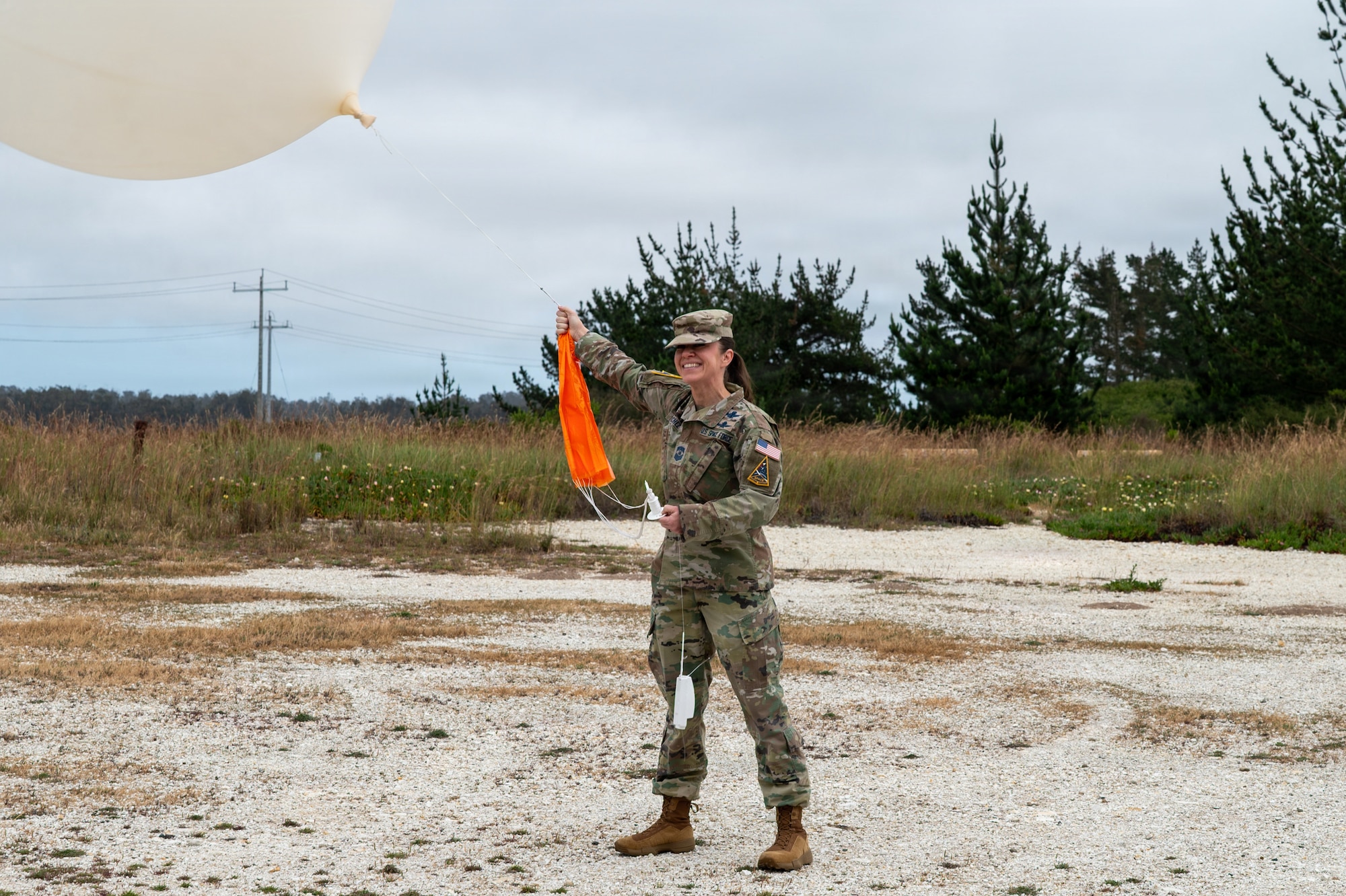 U.S. Space Force Chief Master Sgt. Shannan Sanchez, Space Launch Delta 30 senior enlisted leader, holds a weather balloon outside.