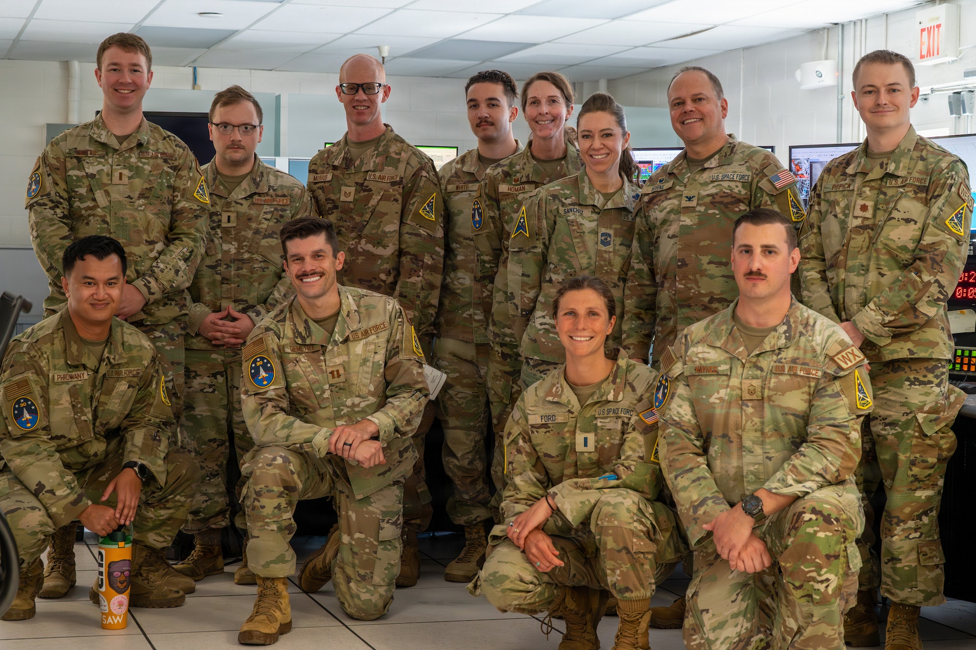 Space Launch Delta 30 leadership and 30th Operations Support Squadron personnel pose for a group photo.