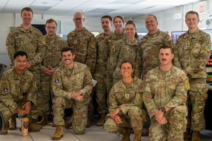Space Launch Delta 30 leadership and 30th Operations Support Squadron personnel pose for a group photo.