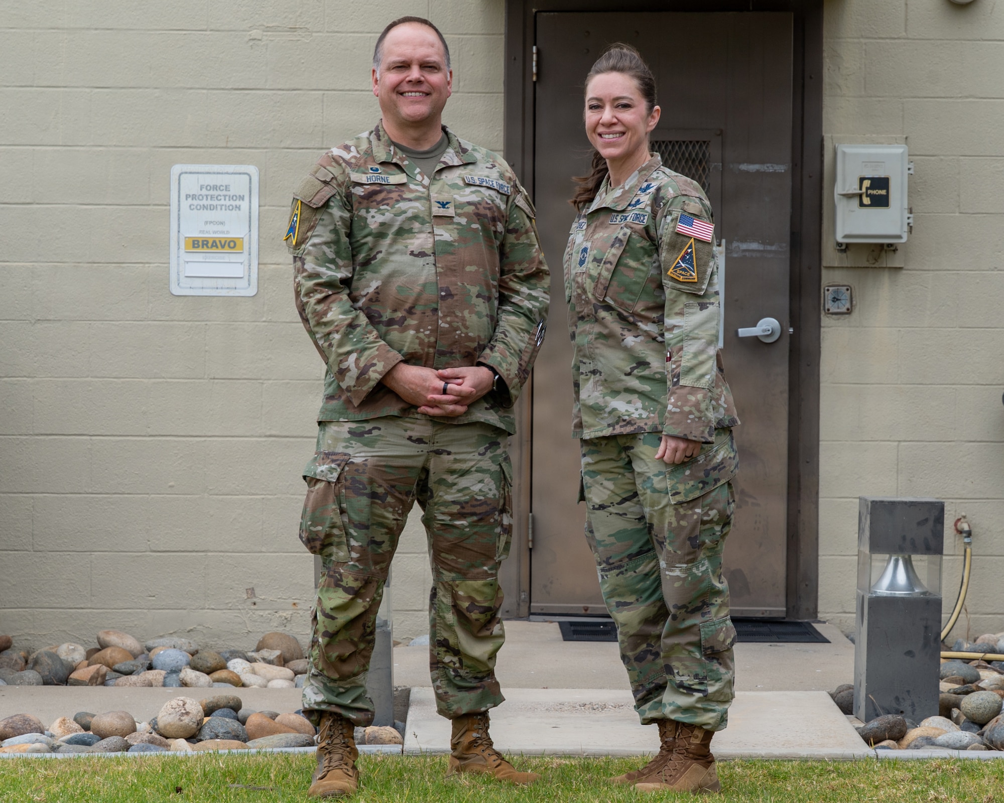 U.S. Space Force Col. James T. Horne III, left, Space Launch Delta 30 commander, and Chief Master Sgt. Shannan Sanchez, right, SLD 30 senior enlisted leader, stand and pose for a photo.