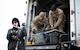 Airmen download equipment from a truck.