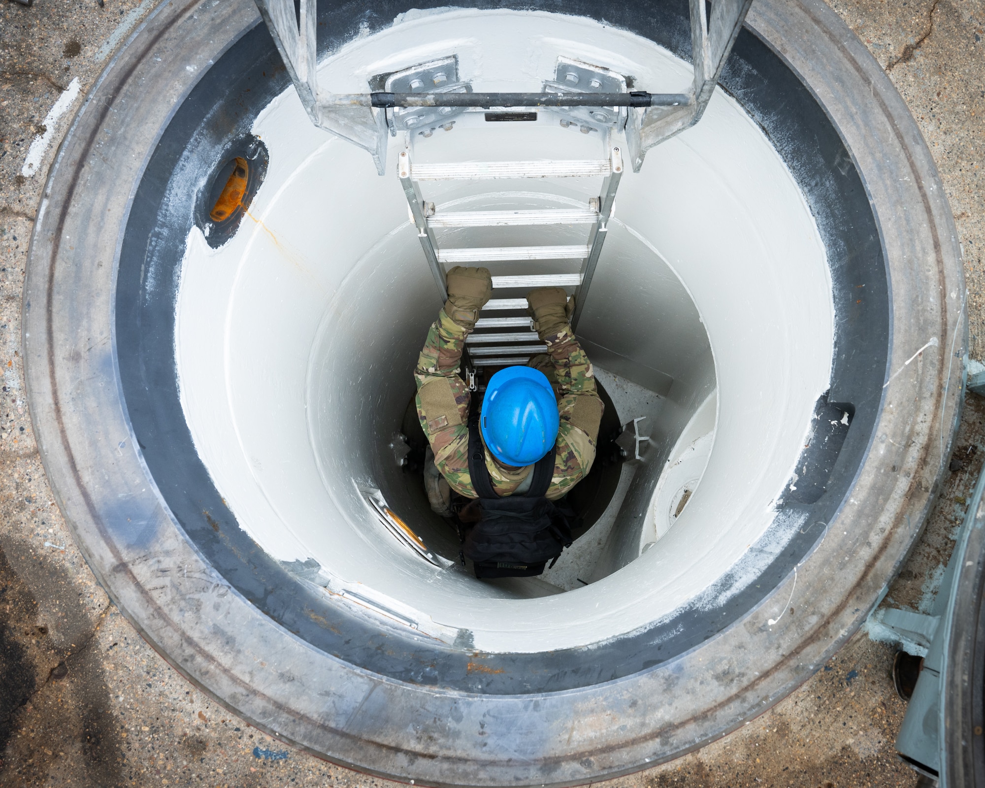 An Airman descends a ladder into a launch facility.