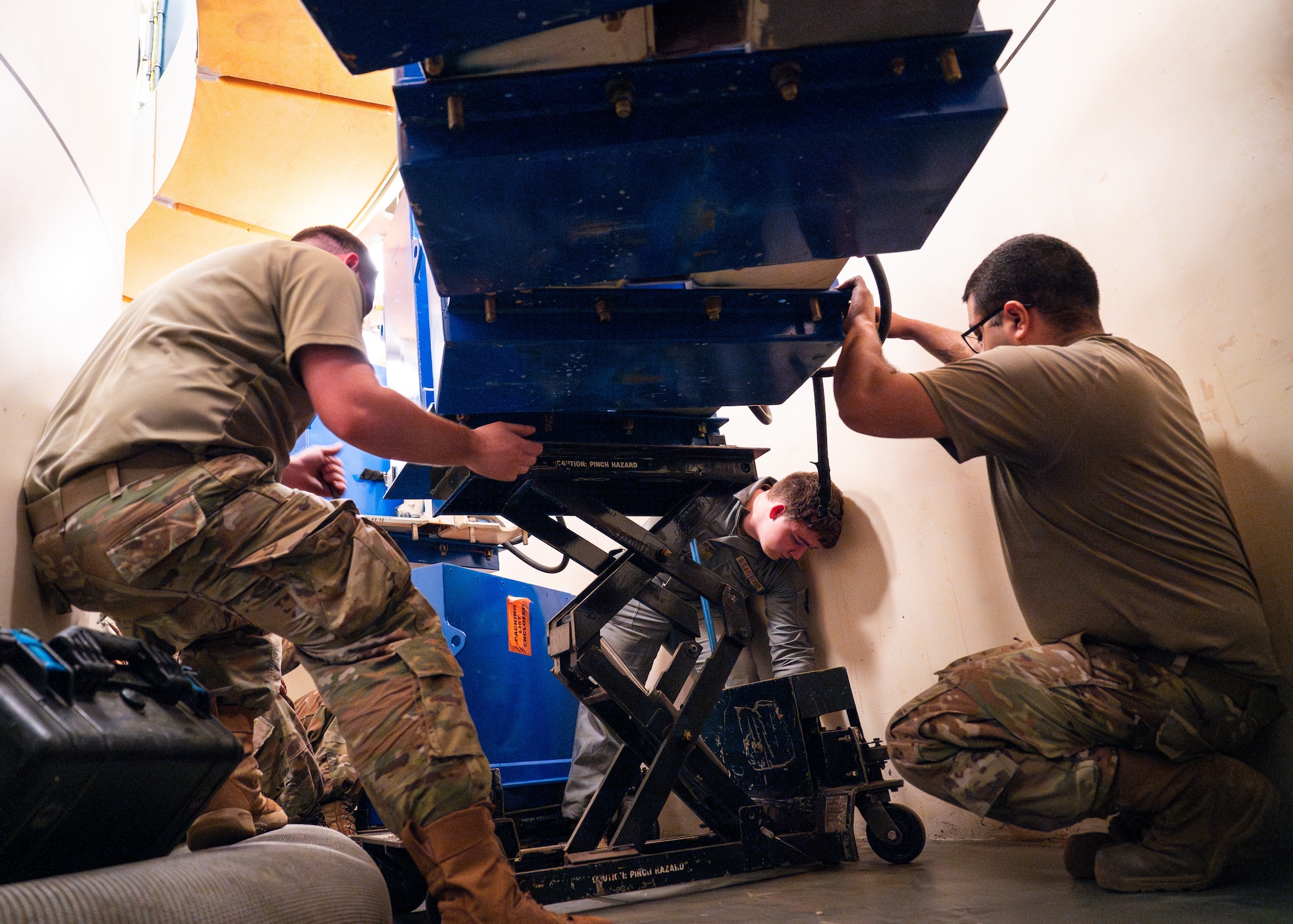 Airmen replace batteries within a launch facility.