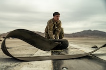 person crouches on ground