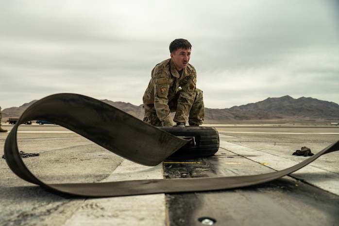 person crouches on ground