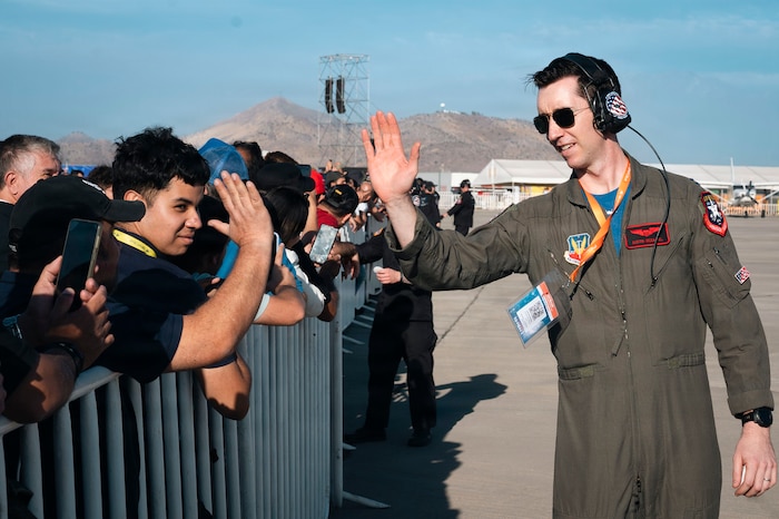 U.S. Air Force Capt. Austin McDaniel, F-35A Lightning II Demonstration Team safety observer, high-fives a spectator during the Feria Internacional del Aire y del Espacio 2026 in Santiago, Chile, April 8, 2026. The F-35A Demonstration Team was one of several U.S. Air Force entities present at FIDAE 2026, reinforcing the importance of enduring international partnerships across Latin America’s largest air, space and defense exhibition. (U.S. Air Force photo by Airman 1st Class Samantha Melecio)