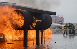Members of the Altus Air Force Base (AFB) Fire Department and Lawton Fire Department participate in a live fire training exercise at Altus Air Force Base, Oklahoma, April 7, 2026. Members of both fire departments worked together to ensure both Altus AFB and Lawton Fire Department personnel met certification requirements for aircraft rescue and firefighting operations. (U.S. Air Force photo by Airman 1st Class Emma Wright)