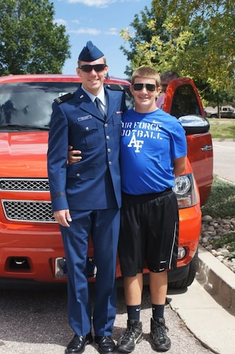 Then, U.S. Air Force Cadet Airman Jeremy Delzer, left, and his brother, Johnathan Delzer, right, pose for a photo at the U.S. Air Force Academy, Colorado Springs, Colorado, in September of 2011. Inspired by visiting his brother at the academy, Johnathan decided to pursue a career in aviation and now works in the 97th Maintenance Group as a U.S. Air Force KC-46 Pegasus aircraft electrician. (Courtesy photo)