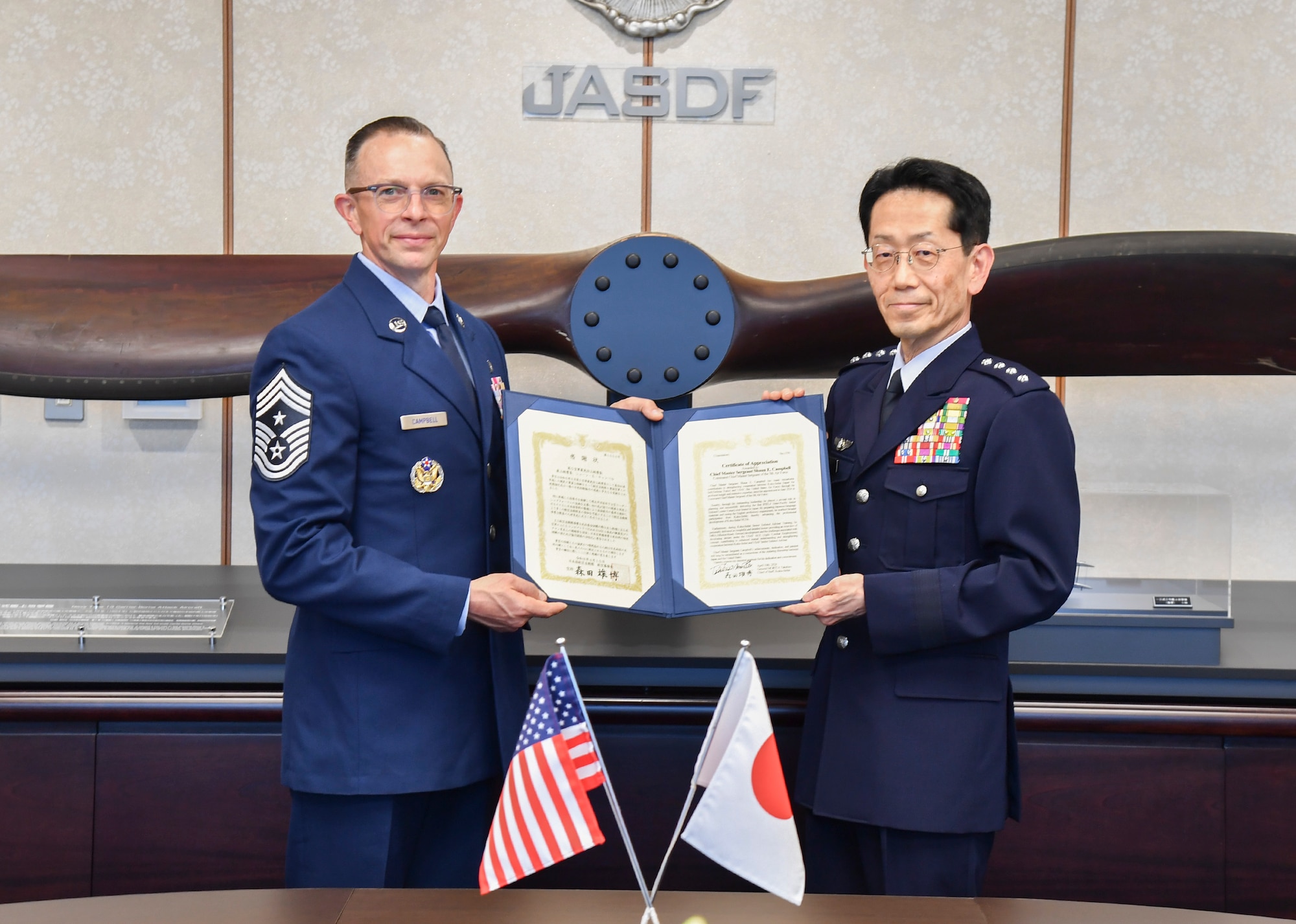 U.S. Air Force Chief Master Sergeant Shaun Campbell and Japan Air Self-Defense Force Gen Takehiro Morita pose for a photo at the Ministry of Defense Tokyo, Japan, April 10, 2026. Campbell received the Certificate of Appreciation, Japan Defense Cooperation Award 2nd Class for his contributions to strengthening the relationship and interoperability between between Koku-Jieitai (Japan Air Self-Defense
Force) and the United States Air Force.