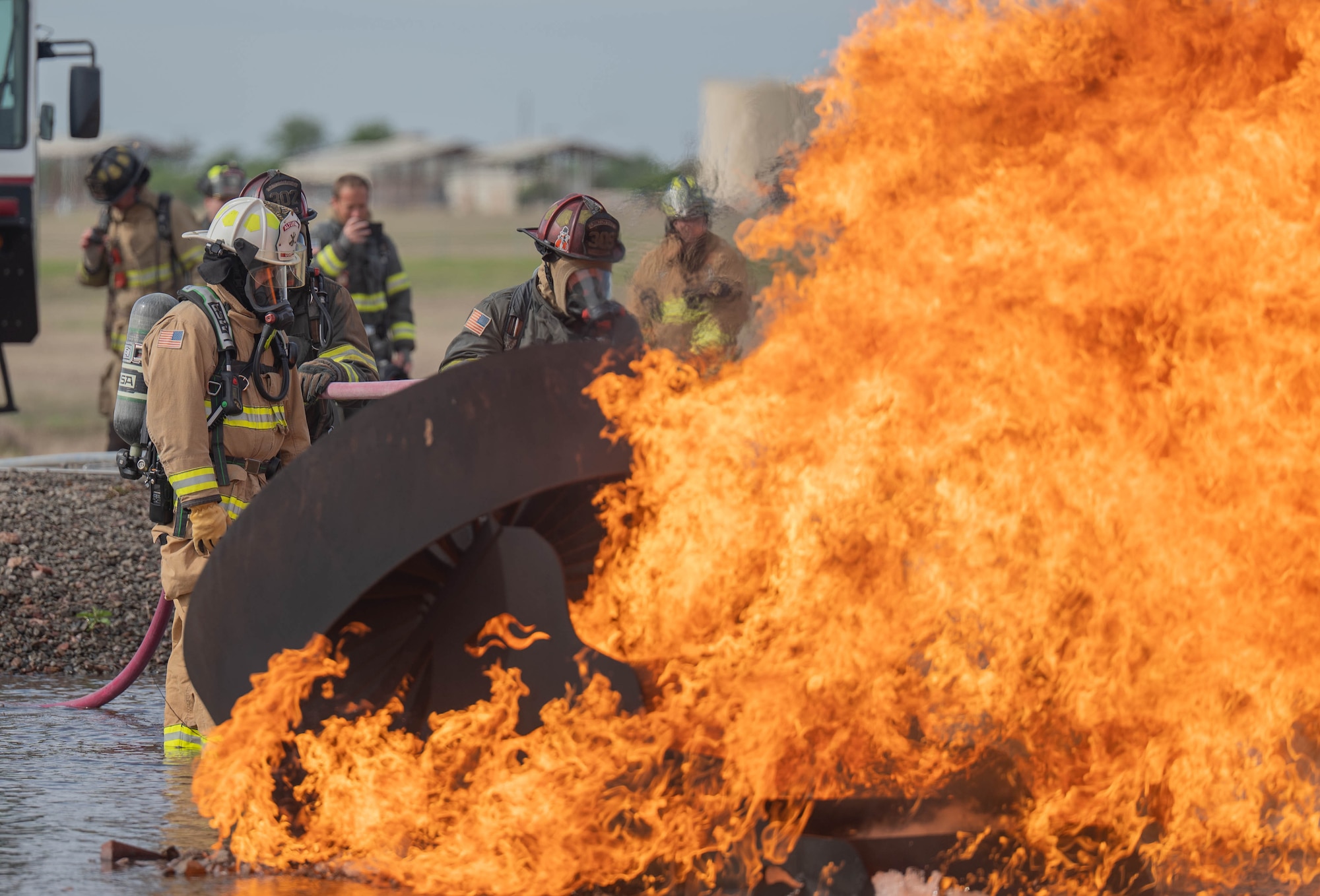Members of the Altus Air Force Base (AFB) Fire Department and Lawton Fire Department participate in a live fire training exercise at Altus Air Force Base, Oklahoma, April 7, 2026. By completing this joint training, both Altus AFB and Lawton Fire Department personnel met certification requirements for aircraft rescue and firefighting operations. (U.S. Air Force photo by Airman 1st Class Emma Wright)