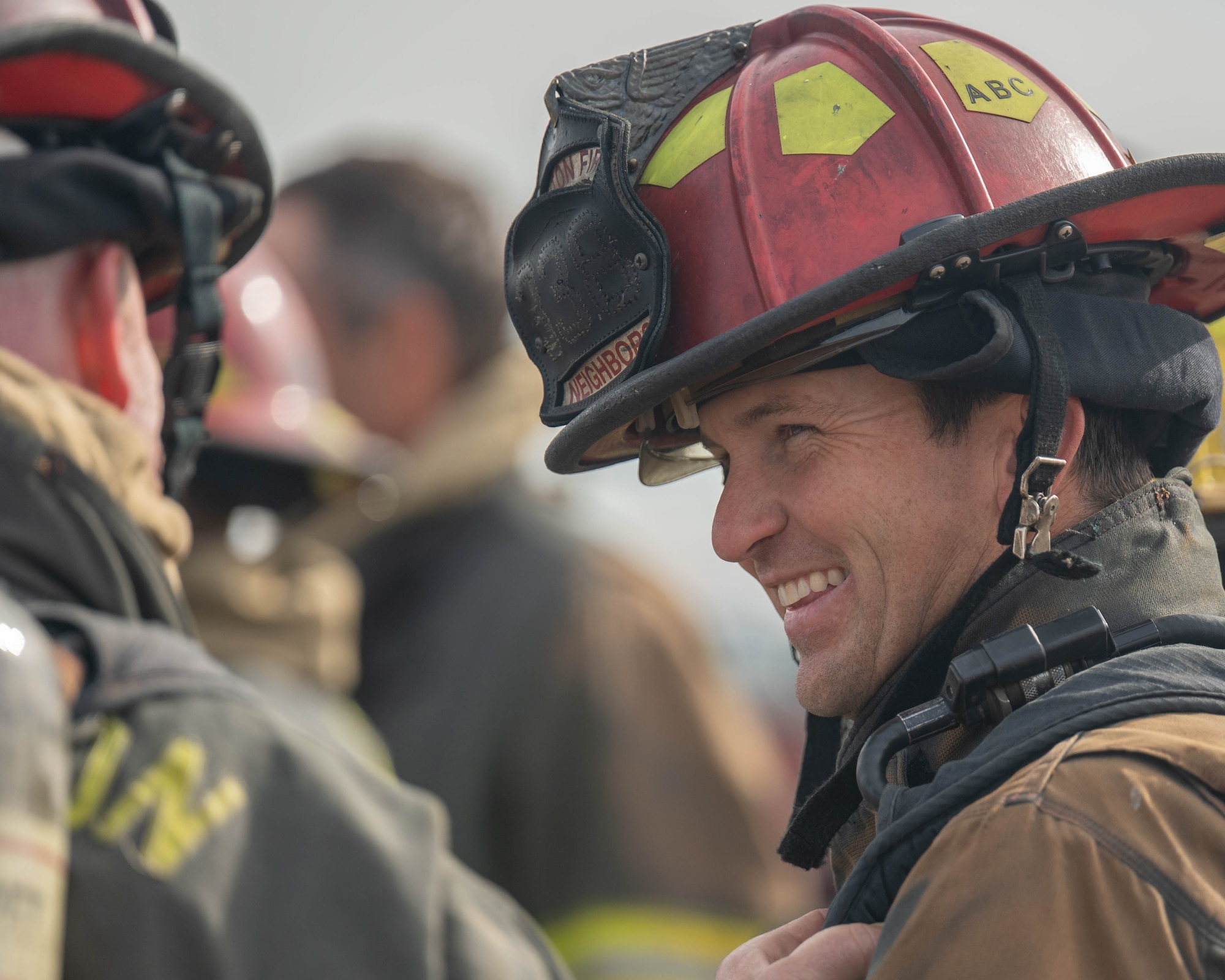 Zachary R. Neighbors, Lawton Fire Department firefighter, talks with a fellow firefighter at Altus Air Force Base (AFB), Oklahoma, April 7, 2026. Members of the Lawton Fire Department traveled to Altus AFB to conduct a live fire training exercise with members of the Altus AFB Fire Department. (U.S. Air Force photo by Airman 1st Class Emma Wright)