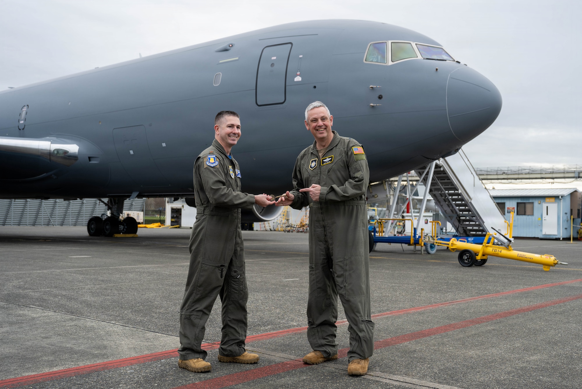 Maj. Kyle Haydel, 22nd Operations Group KC-46A Pegasus pilot, presents a key to Brig. Gen. Corey Simmons, U.S. Transportation Command director of operations in Everett, Washington, April 3, 2026. The key was a ceremonial memento for Simmons as he took command of the latest KC-46. (U.S. Air Force photo by Airman 1st Class Patrick O’Neill)