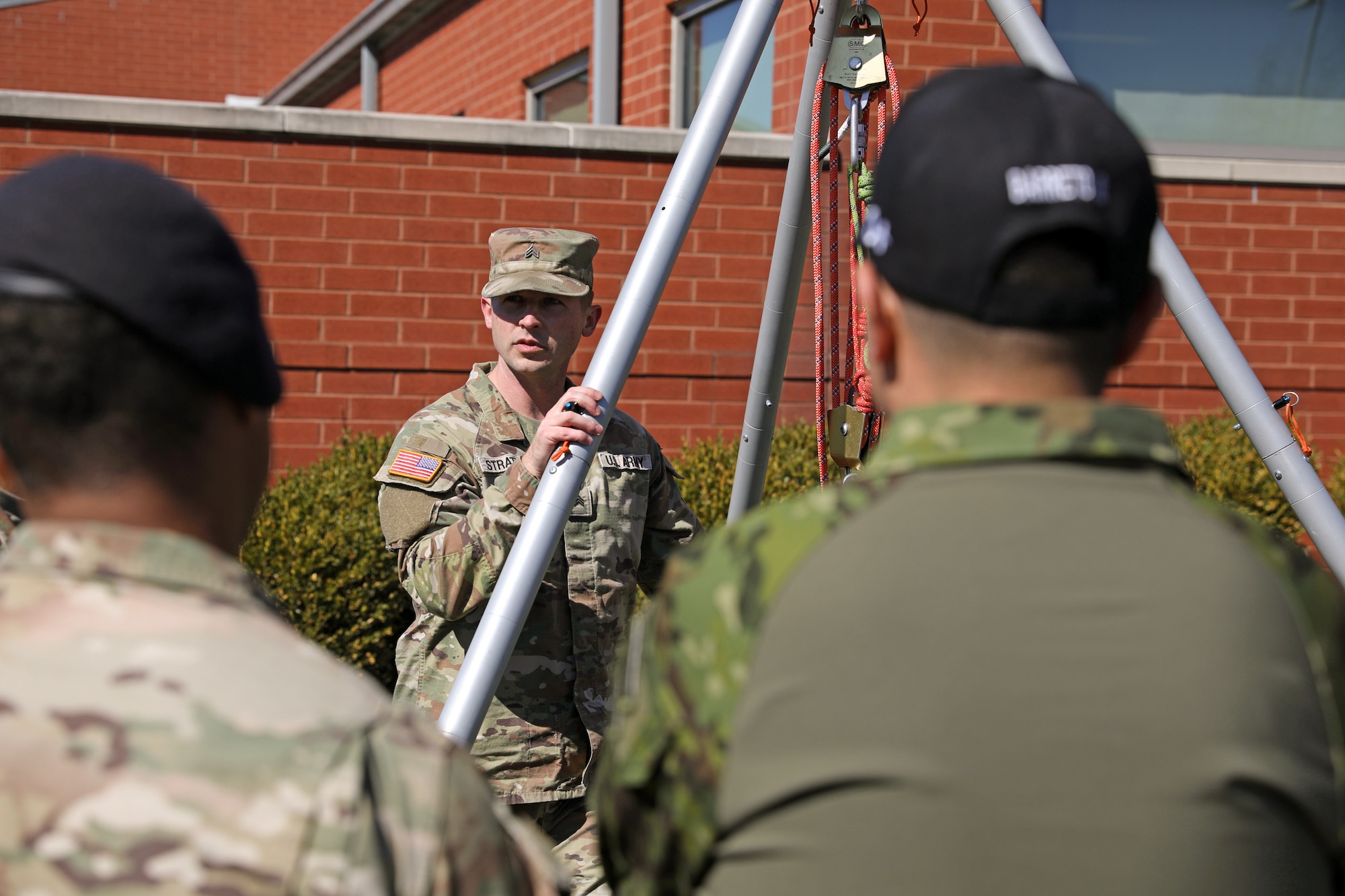 U.S. Army Sgt. Andrew Stratton, a non-commissioned officer with the Kentucky National Guard’s Chemical, Biological, Radiological, Nuclear and high-yield Explosive Enhanced Response Force Package,  gives a rescue demonstration on the extract element cradle system to soldiers with the Ecuadorian Army during their State Partnership Program visit with the Kentucky Army National Guard’s 103rd Chemical Battalion at the unit’s readiness center in Burlington, Ky., March 12, 2026. The visit provided an opportunity for partner forces to exchange knowledge, strengthen professional relationships, and enhance cooperation between the two militaries. (U.S. Army National Guard photo by Sgt. 1st Class Benjamin Crane)